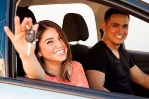 People Smiling in Car Holding Car Keys