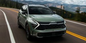 green 2024 Kia Sportage driving down a highway | Lanham, MD