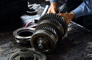 Engineer hands fixing engine power transmission gears box | Lanham, MD