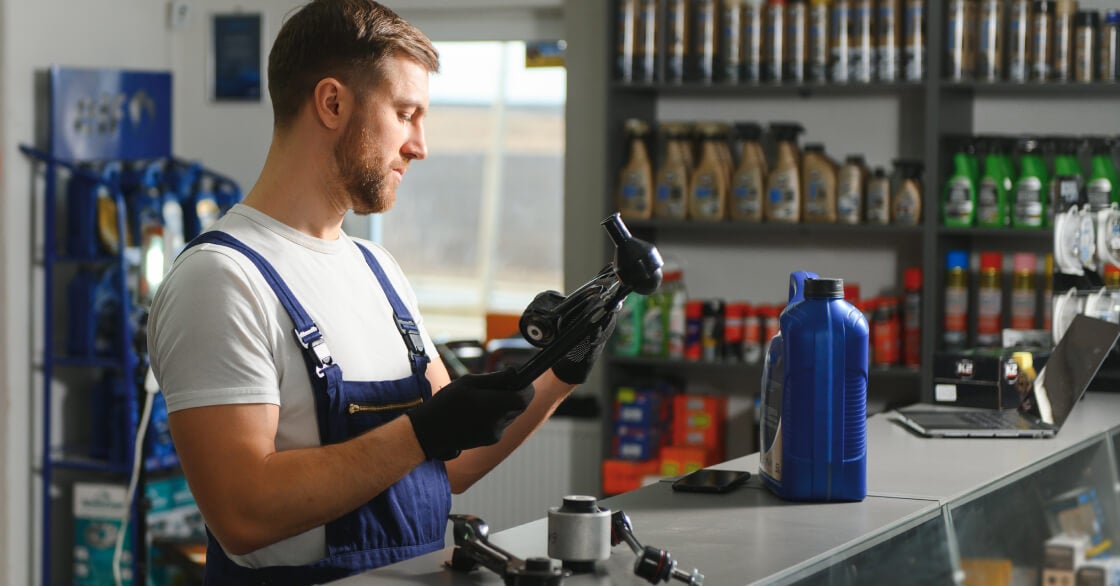 Man at counter inspecting parts