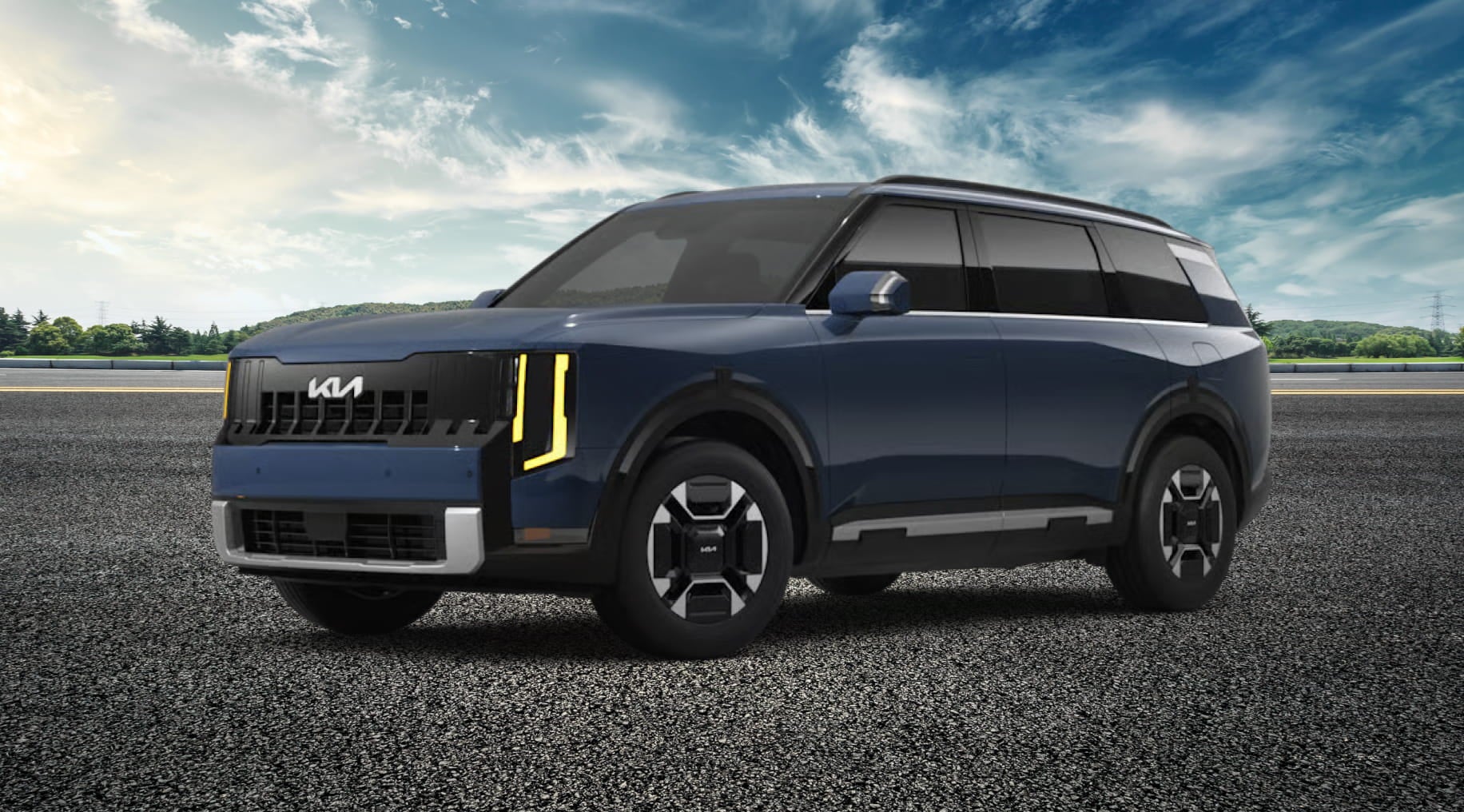 A blue Kia Telluride Hybrid SUV with modern, angular headlights is parked on a paved surface under a bright, partly cloudy sky.