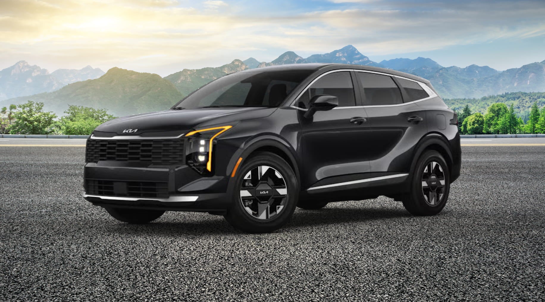 A black Kia Sportage SUV parked on paved surface with mountains and greenery in the background.