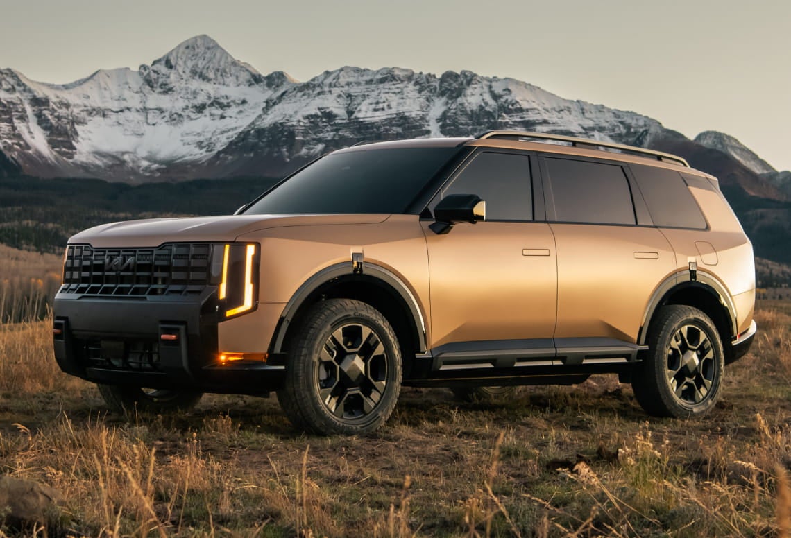 2027 Kia Telluride parked in a rugged landscape with snow-covered mountains in the background.